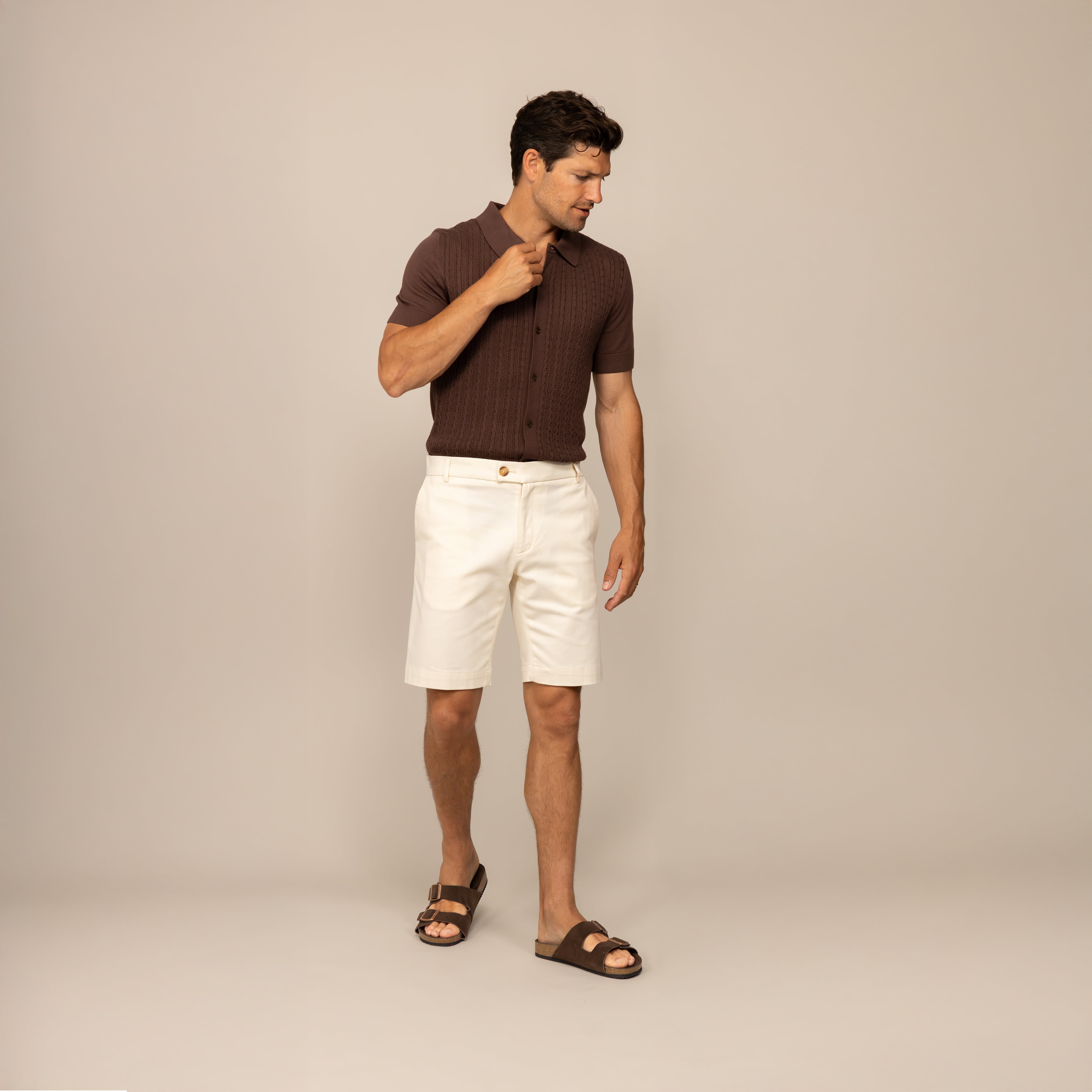 Man wearing Marame Chino Shorts in Ivory Stone, front view.