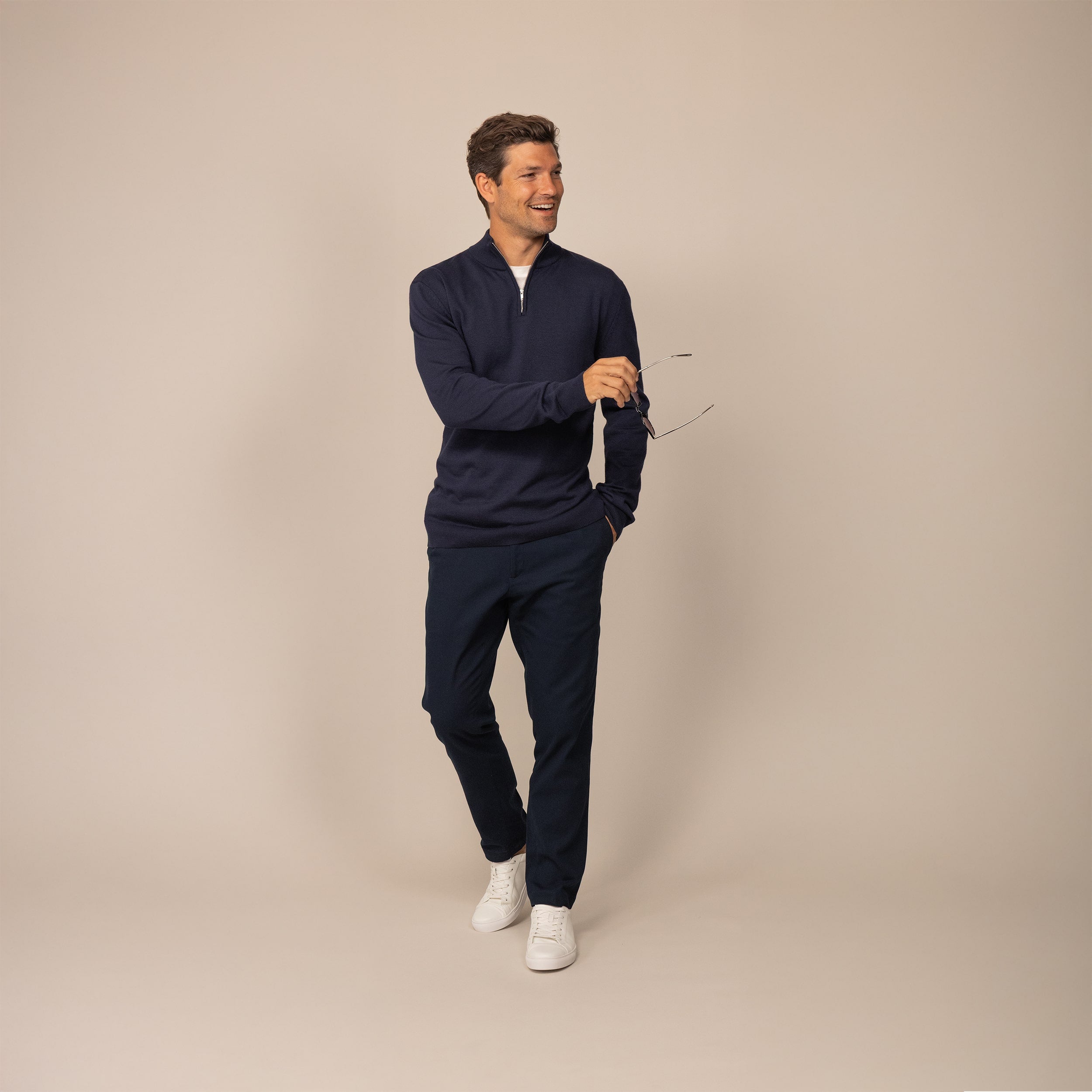 Man wearing a navy half zip jumper, front view.
