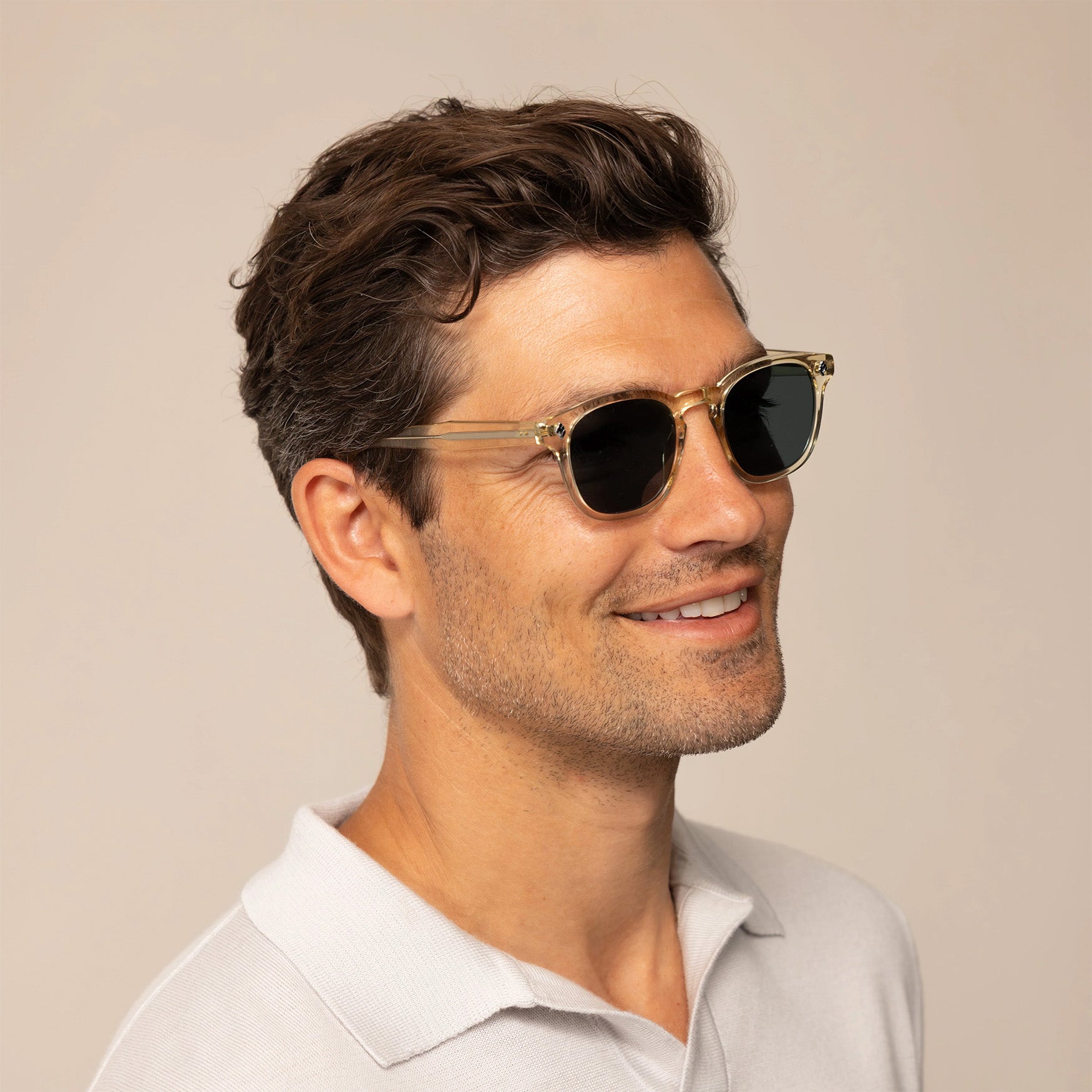 Man wearing Garrett Leight Ace Sun Sunglasses in Pure Glass, front view.