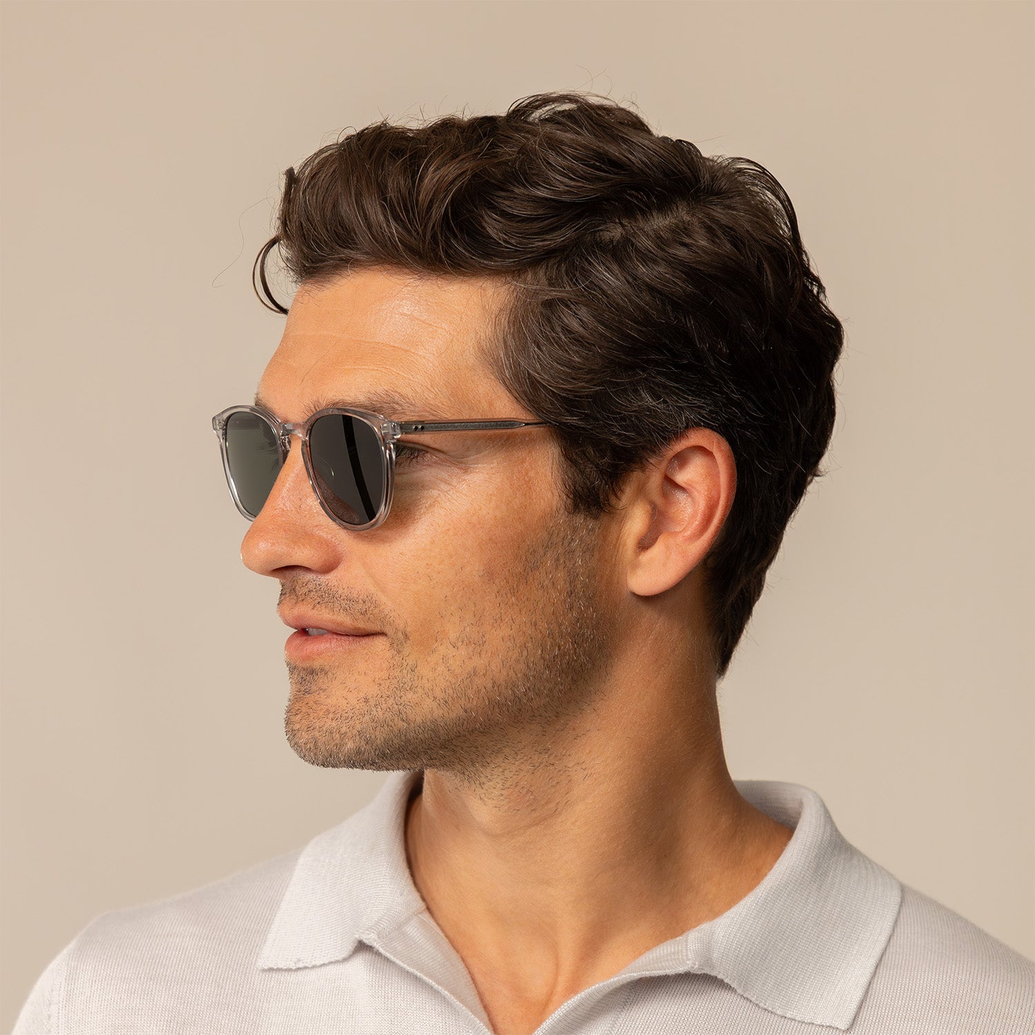 Man wearing Garrett Leight Kinney Sun Sunglasses in Light Light Grey, side view.