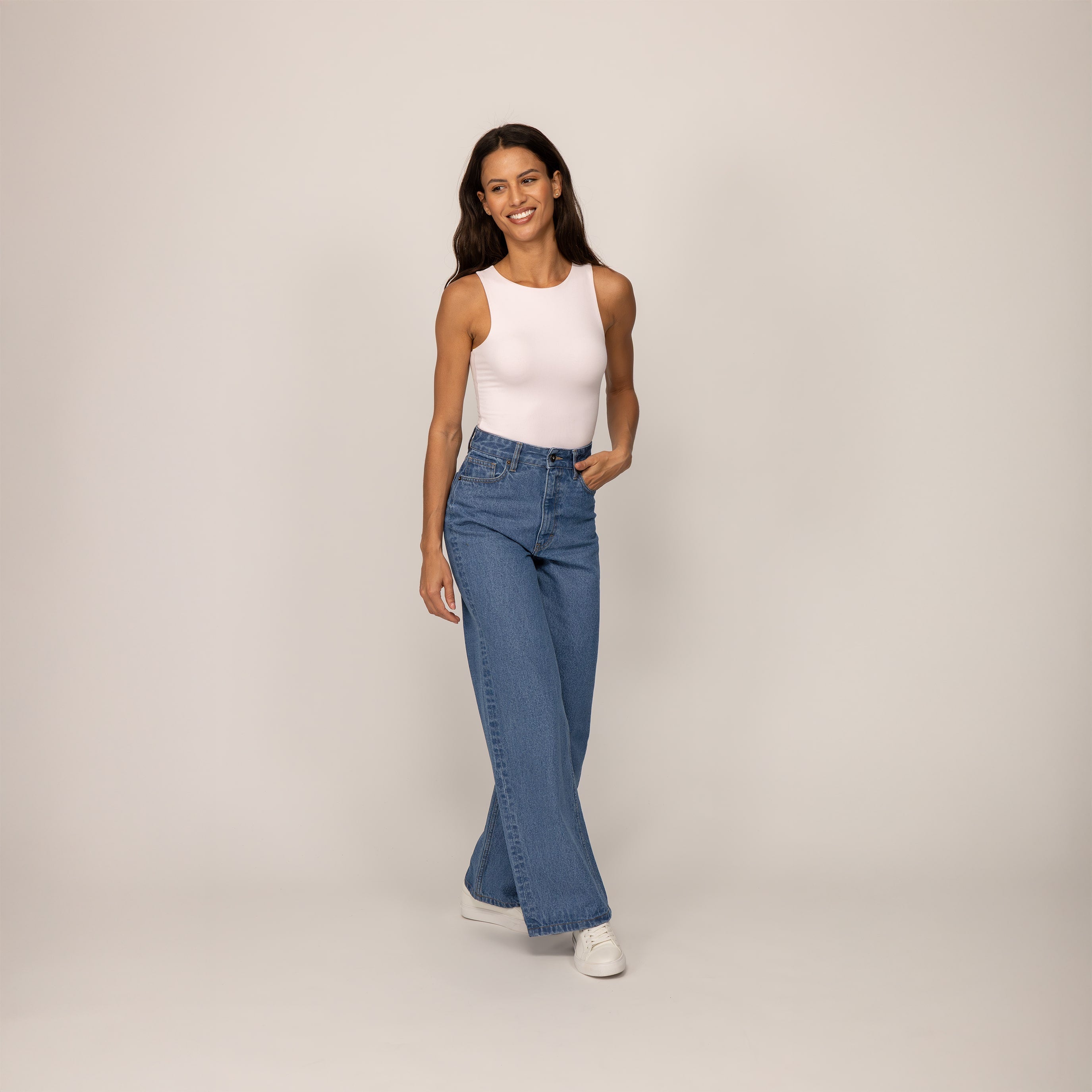 Woman wearing Marame High-Waisted Wide Leg Jeans in Light Wash Denim, front view.