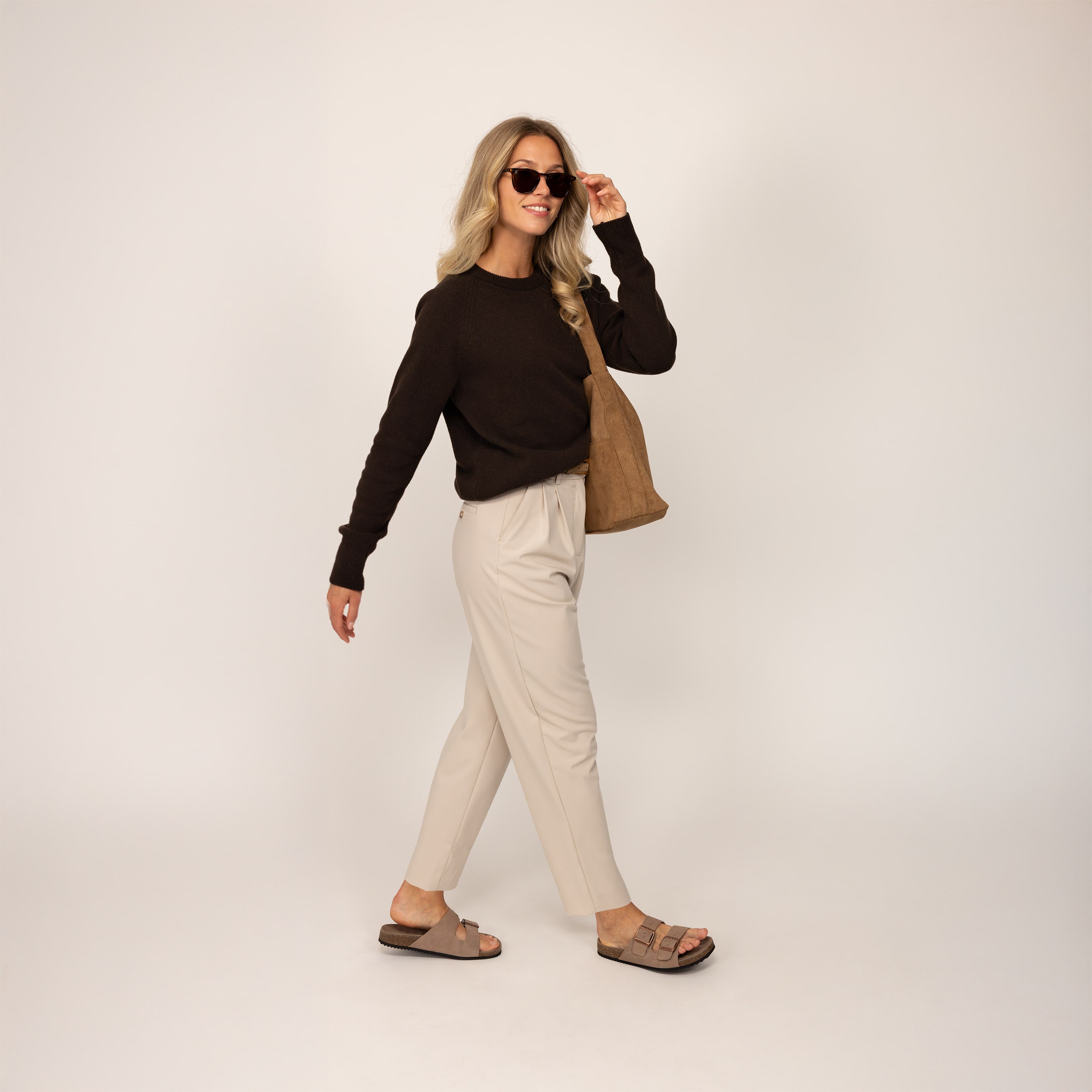 Woman wearing a Marame Merino Wool Crew Neck Jumper in Rich Chocolate, full view.