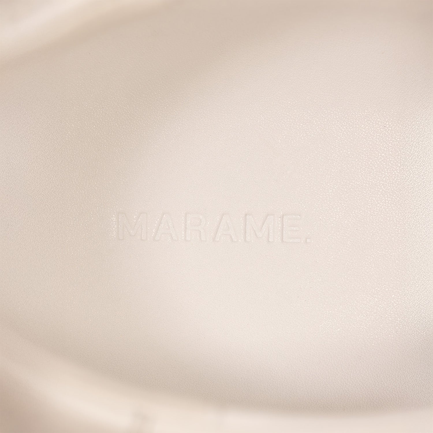 Woman wearing Marame Smart Leather Trainers in White, closeup.