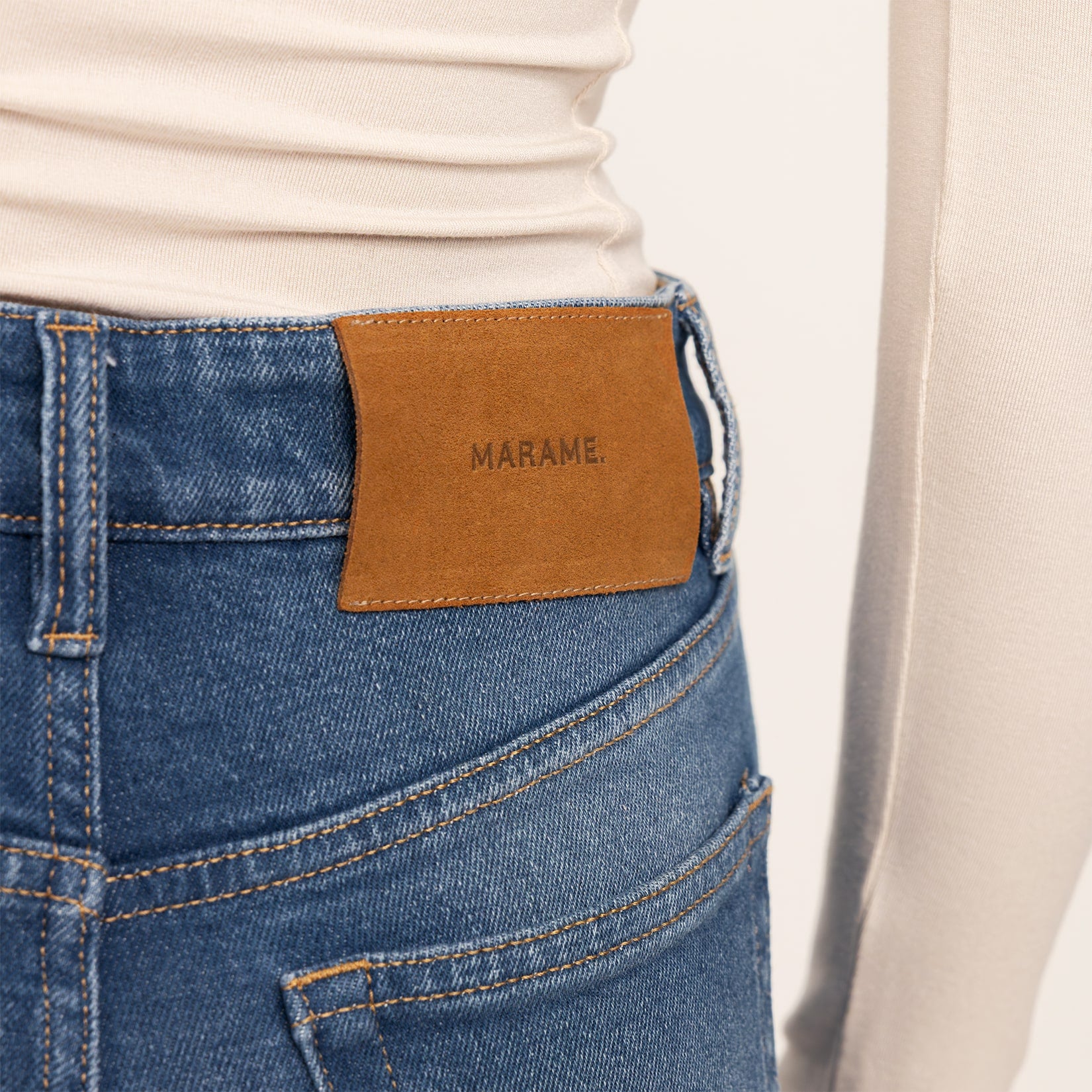 Woman wearing Straight Leg Jeans in Deep Navy Wash Denim, detail.