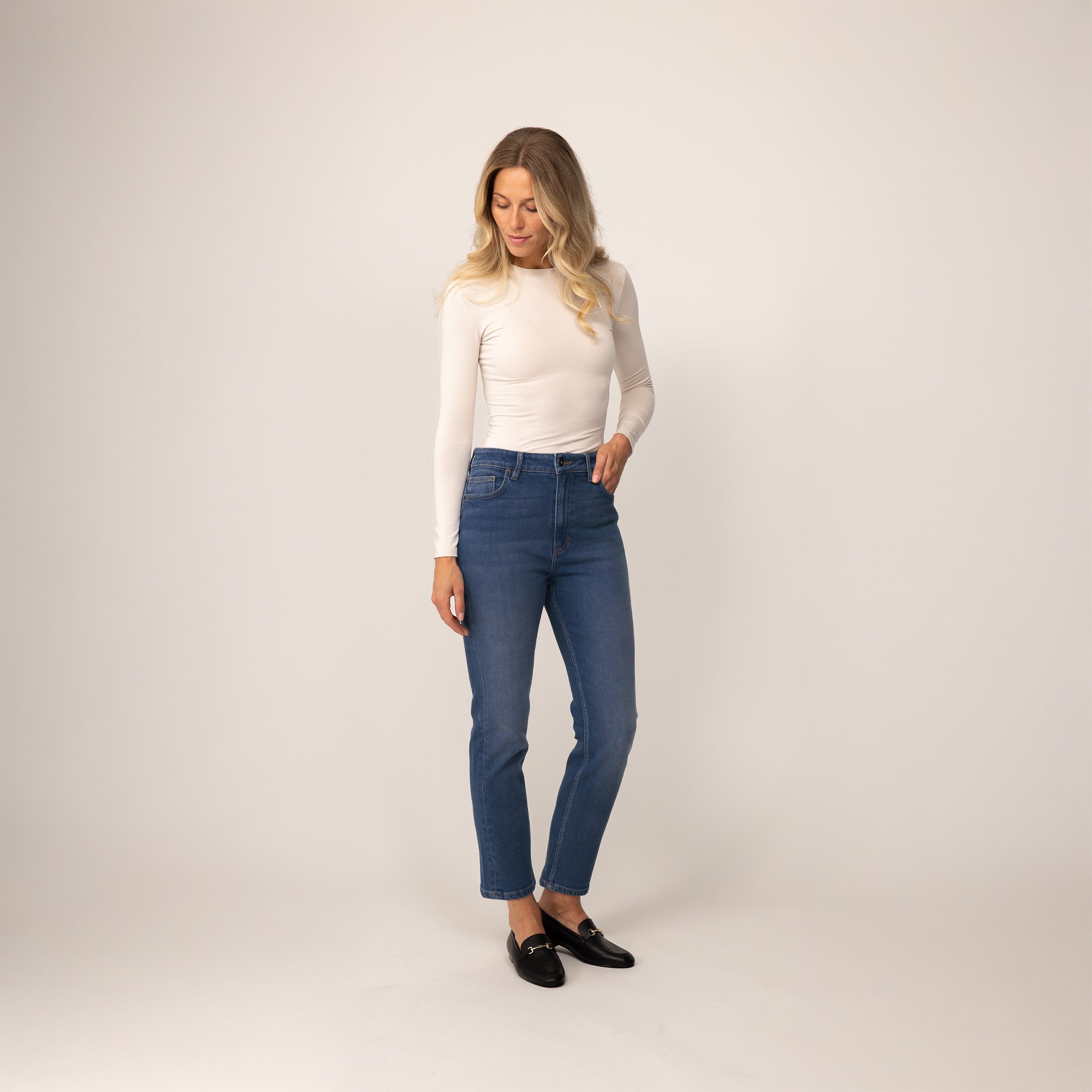 Woman wearing Marame Straight Leg Jeans in Deep Navy Wash Denim, front view.