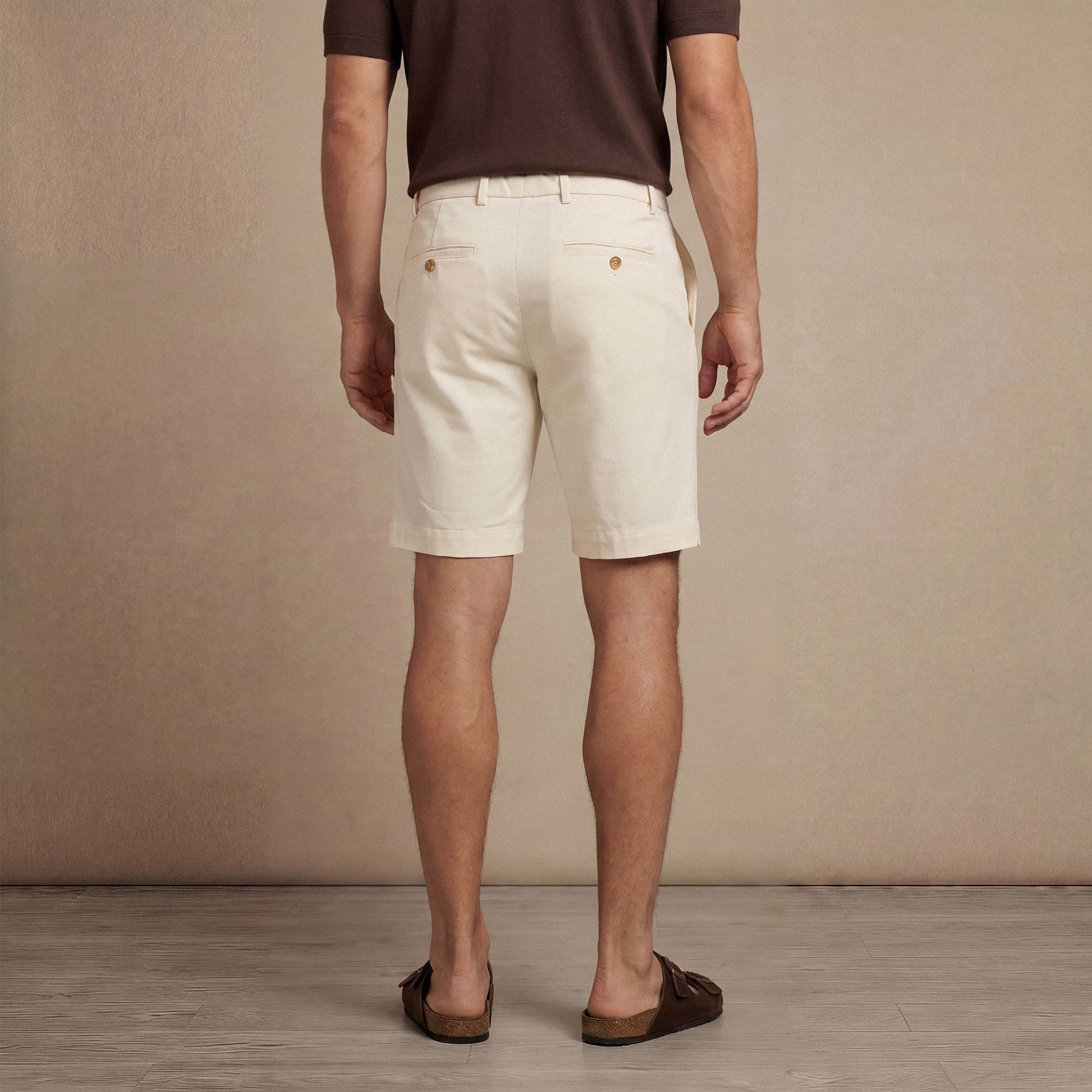Man wearing Marame Chino Shorts in ivory stone back view. |ivory stone