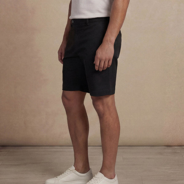 Man wearing Marame Chino Shorts in Black, side view. |black