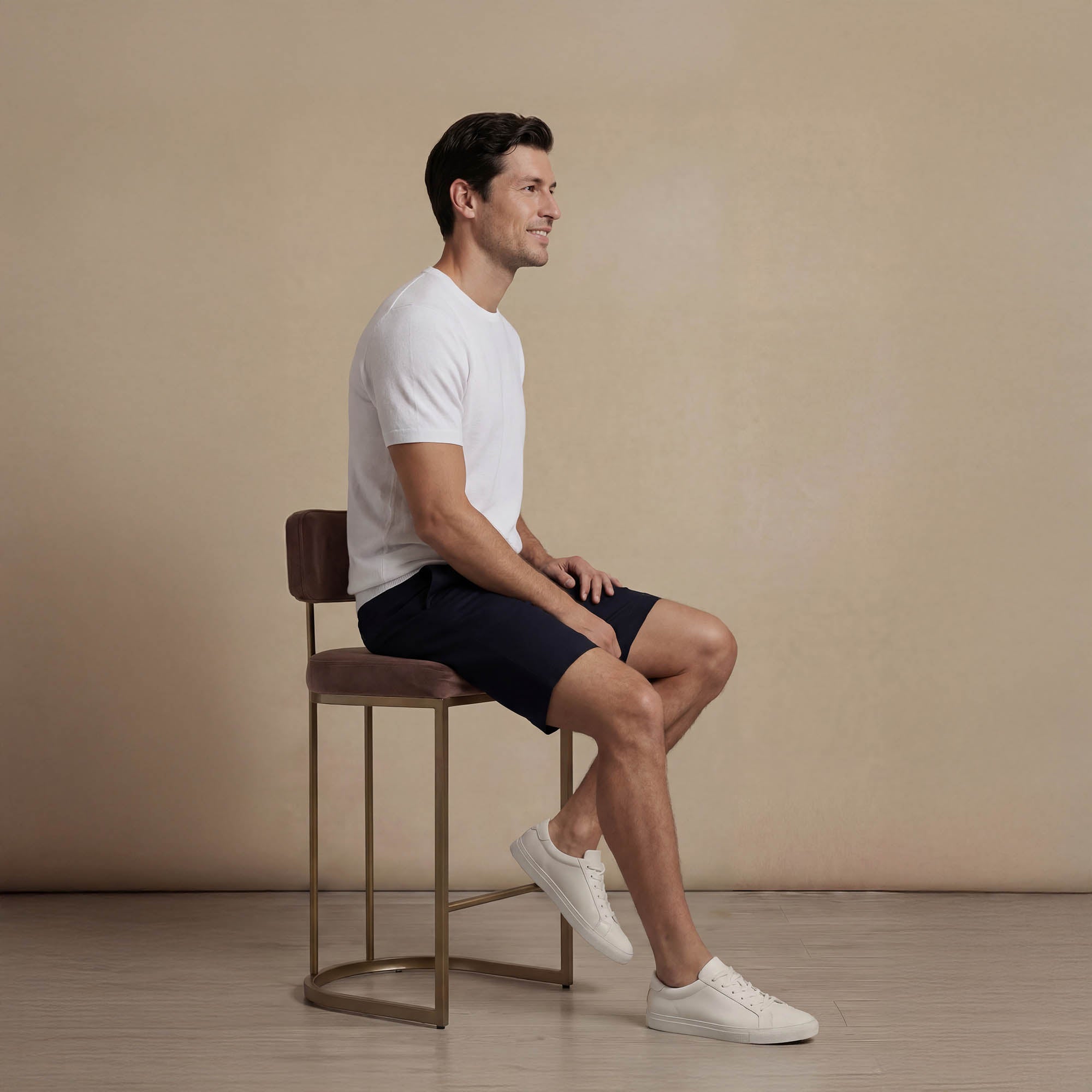 Man wearing Marame Chino Shorts in navy, seated view. |navy