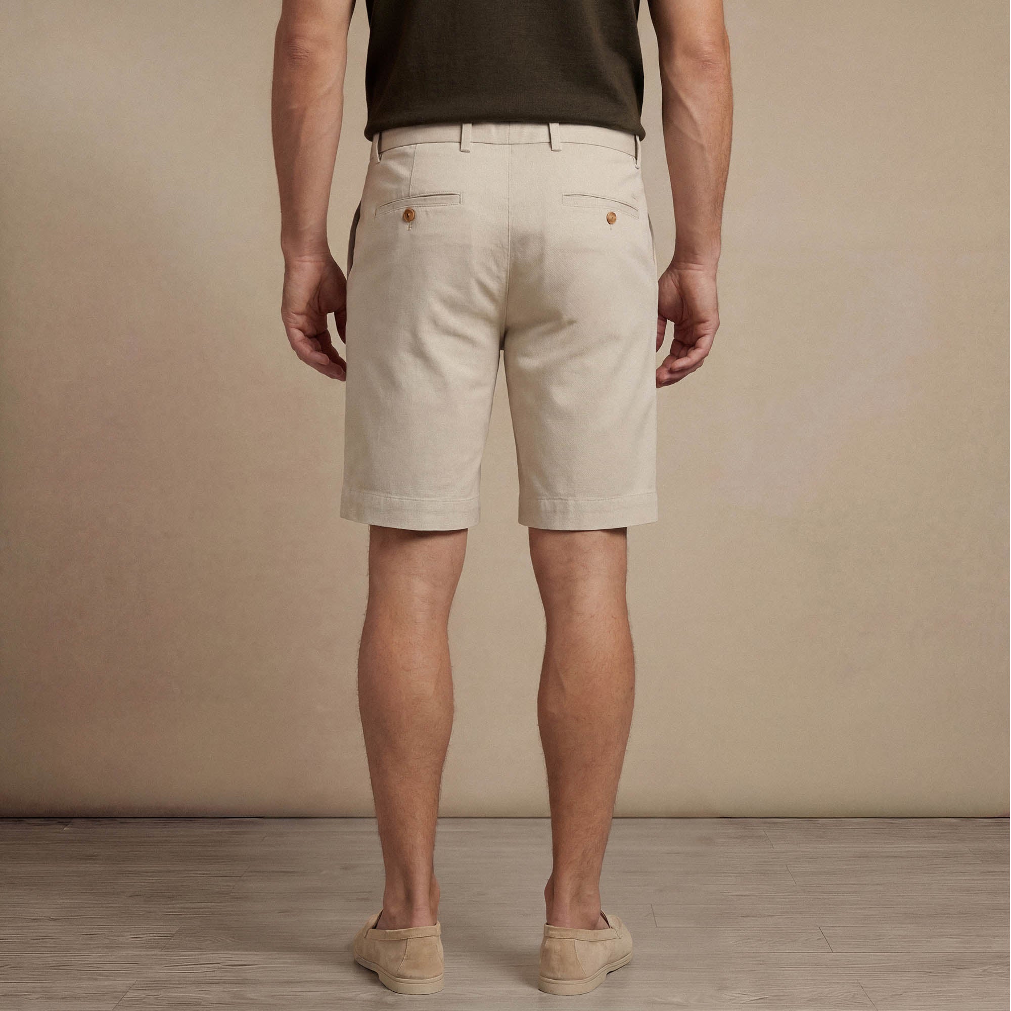 Man wearing Marame Chino Shorts in almond taupe back view. |almond taupe