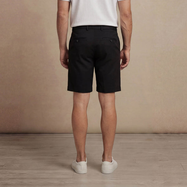Man wearing Marame Chino Shorts in Black, back view. |black