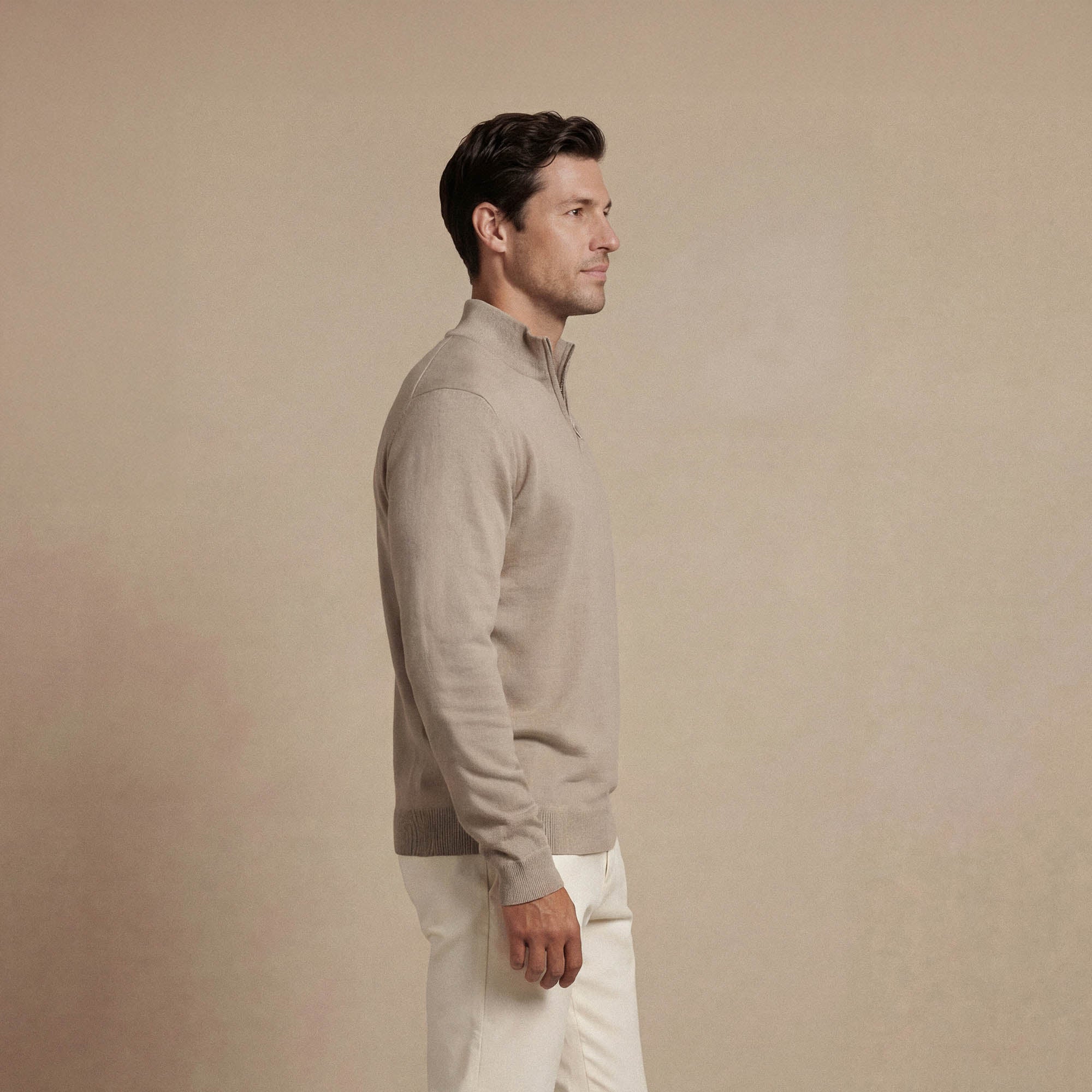 Man wearing a navy half zip jumper, back view. |putty dove