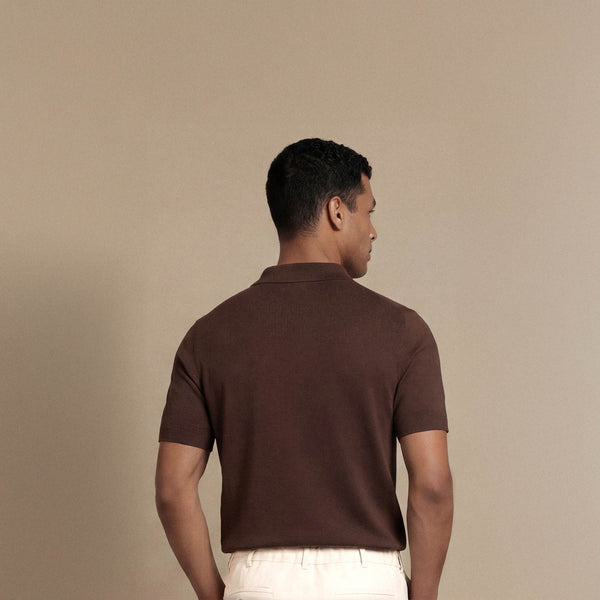 Man wearing Marame cable knit shirt in conker brown, back view. |conker brown