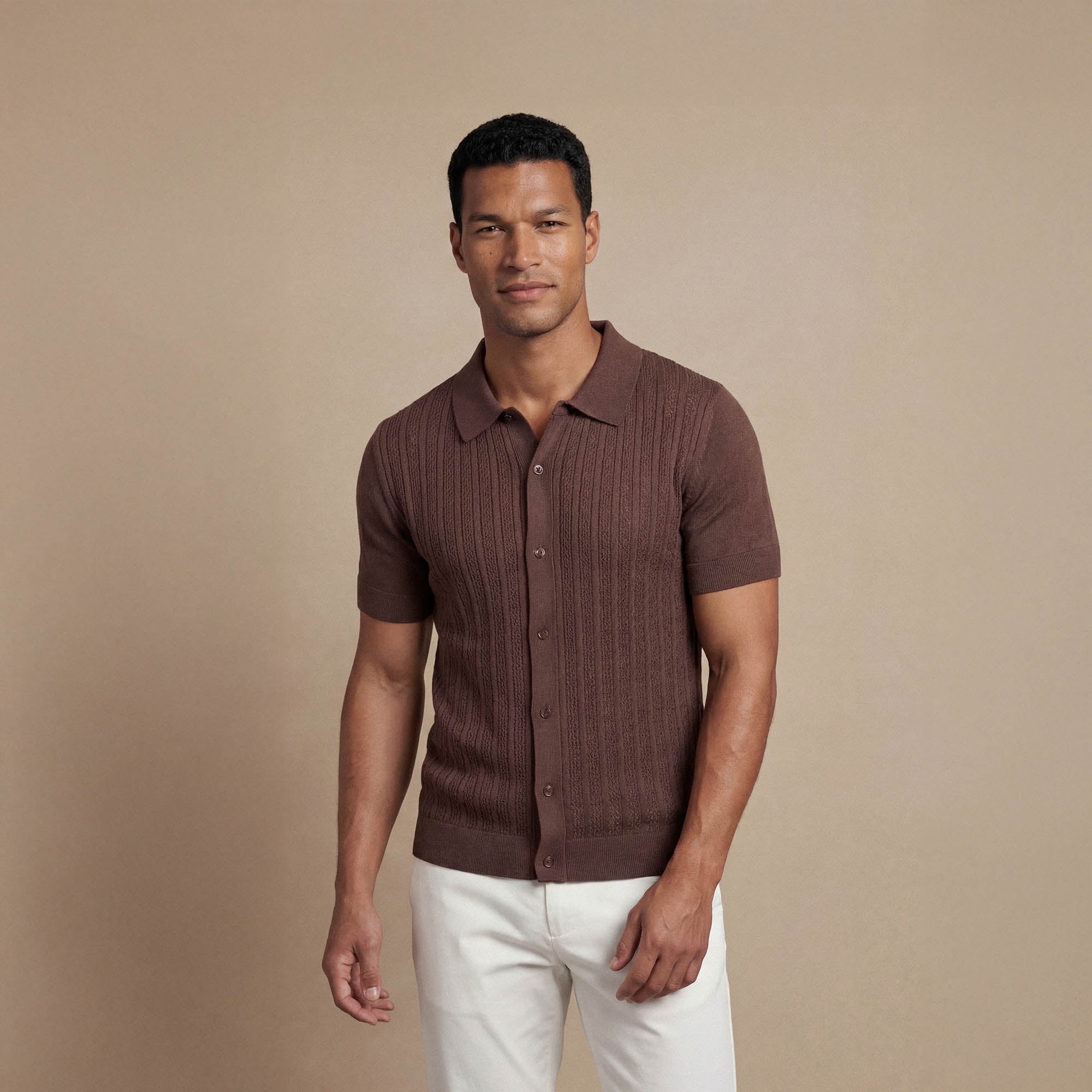 Man wearing Marame cable knit shirt in conker brown, front view. |conker brown