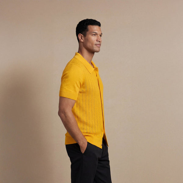 Man wearing Marame cabe knit shirt in citrus, side view. |citrus