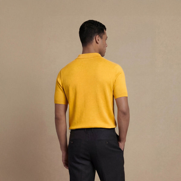 Man wearing Marame cabe knit shirt in citrus, back view. |citrus