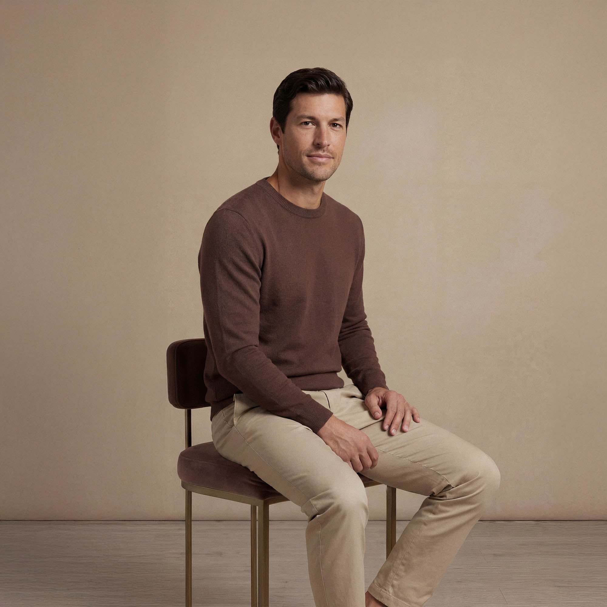 Man wearing a Marame Fine Knit Crew Neck Jumper in brown seated view. |conker brown
