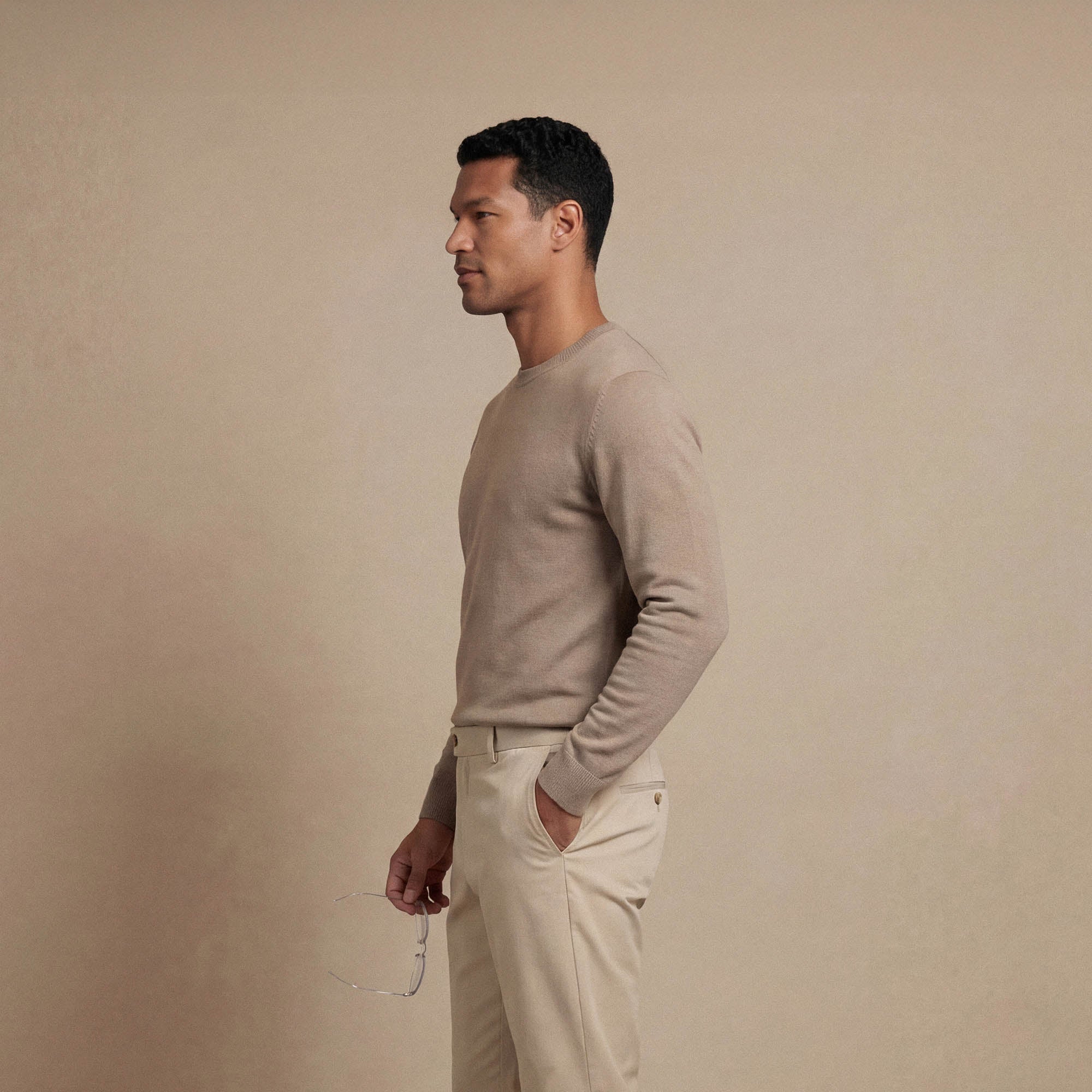 Man wearing a Marame Fine Knit Crew Neck Jumper in putty dove side view. |putty dove