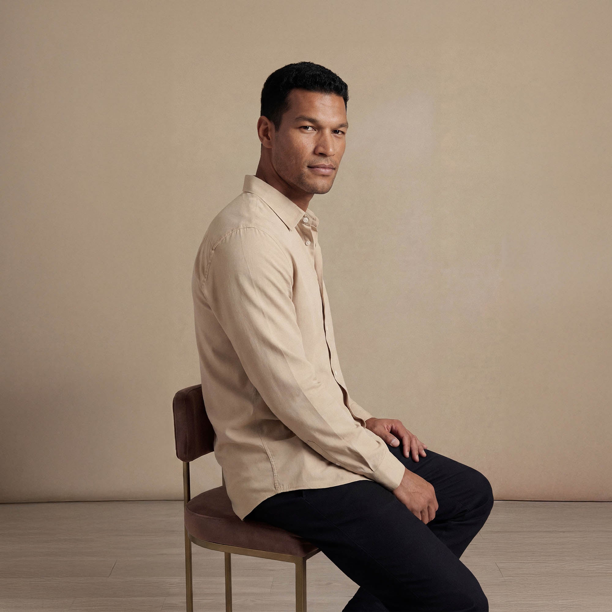 Man wearing Marame Lyocell/Linen Blend Casual Long Sleeve Shirt in Olive Grove, seated view. |drift beige