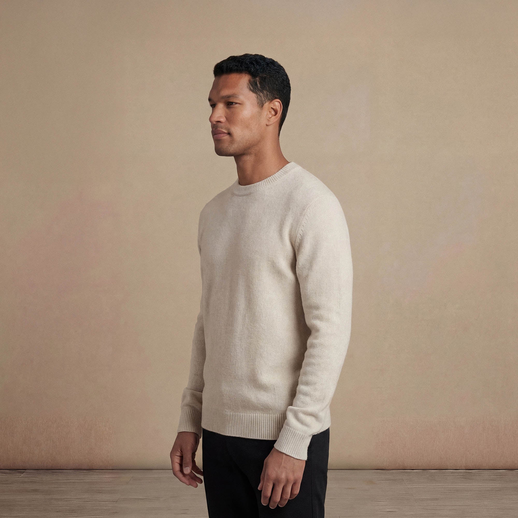Man wearing a Marame Merino Wool Crew Neck Knit Jumper in side view.|speckled grey