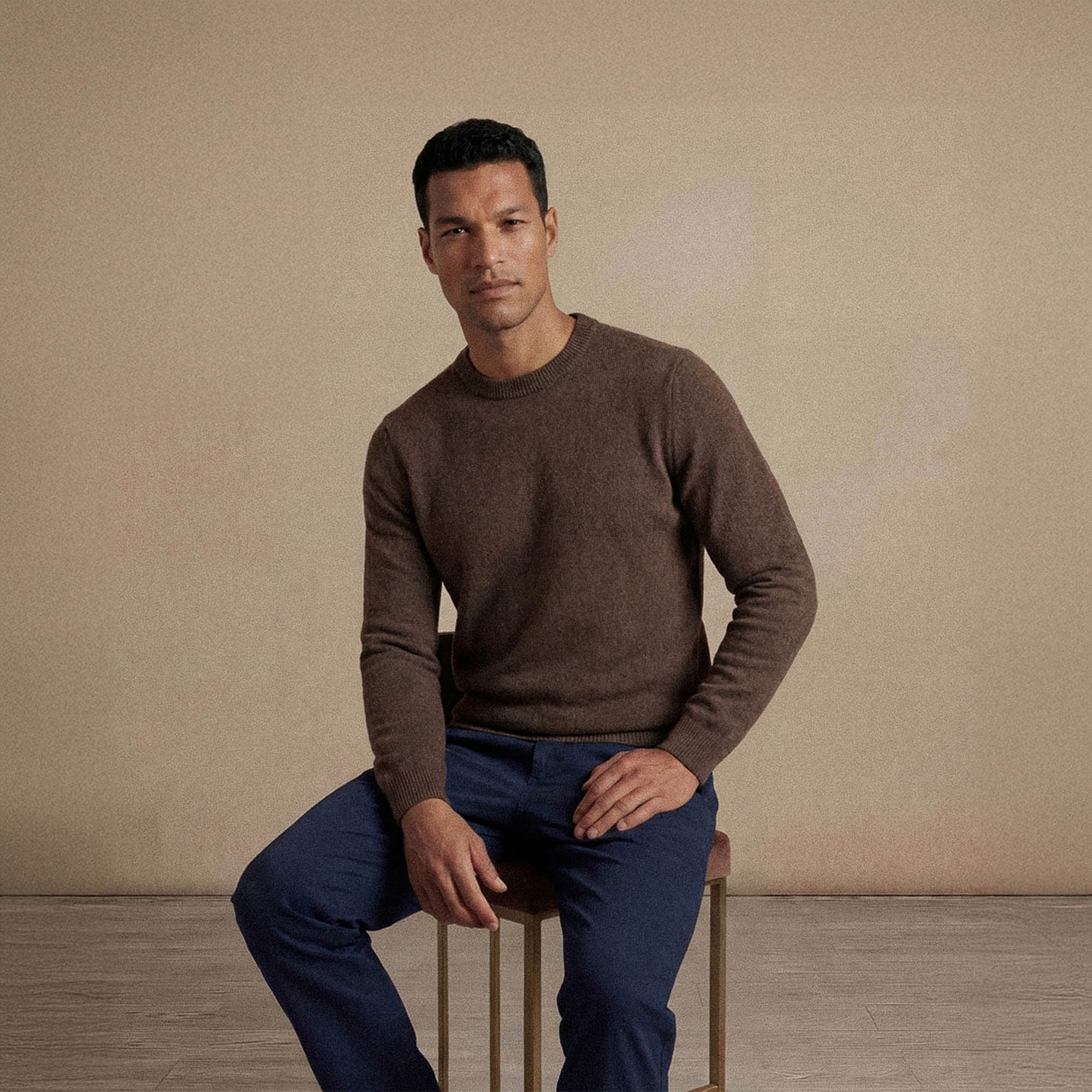 Man wearing a Marame Merino Wool Crew Neck Knit Jumper in seated view.|wholemeal
