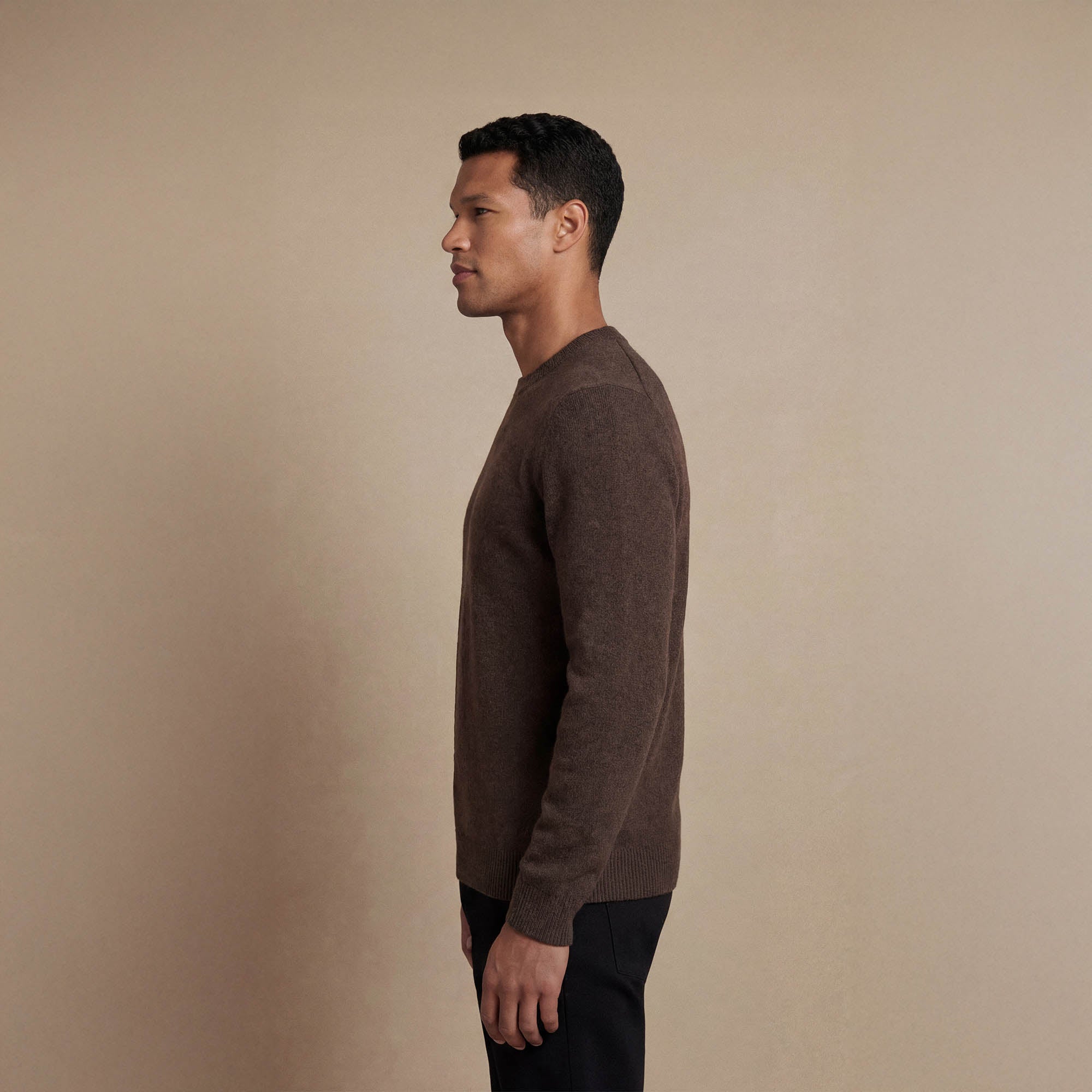 Man wearing a Marame Merino Wool Crew Neck Knit Jumper in side view.|wholemeal