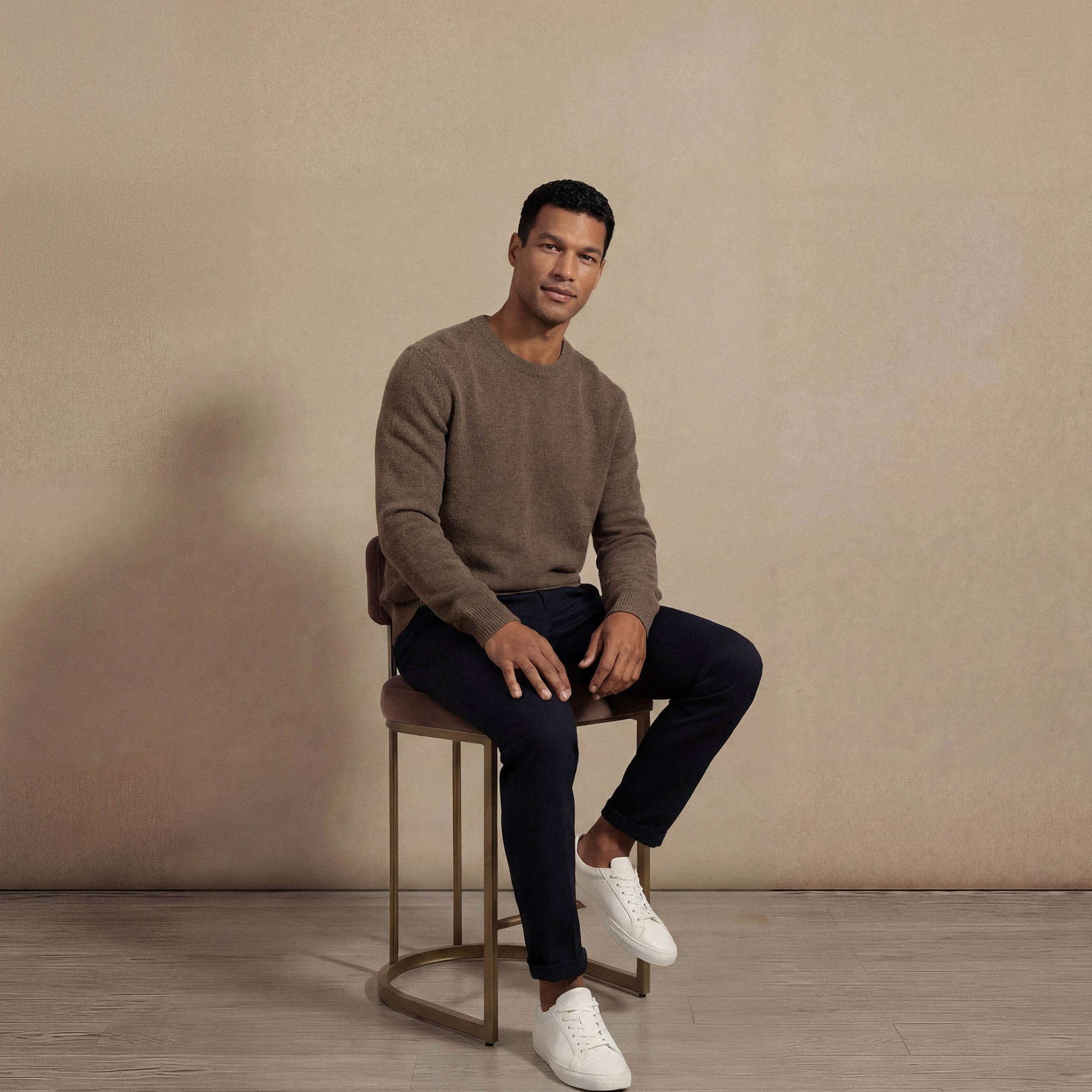 Man wearing a Marame Merino Wool Crew Neck Knit Jumper in seated view.|wholemeal