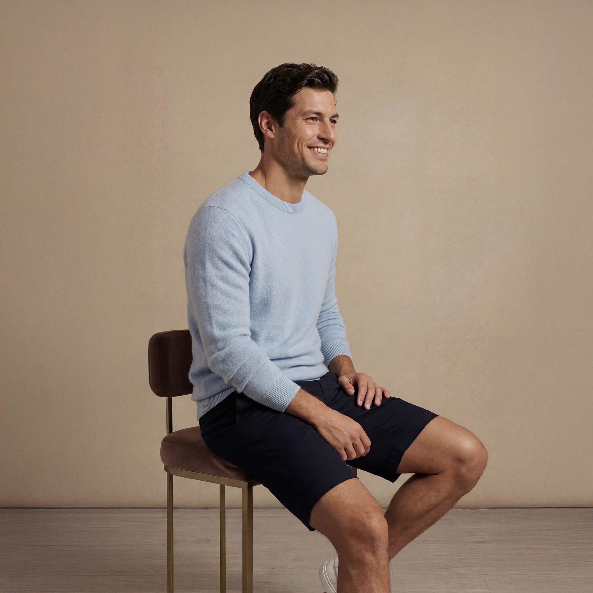 Man wearing a Marame Merino Wool Crew Neck Knit Jumper in seated view.|blushing blue