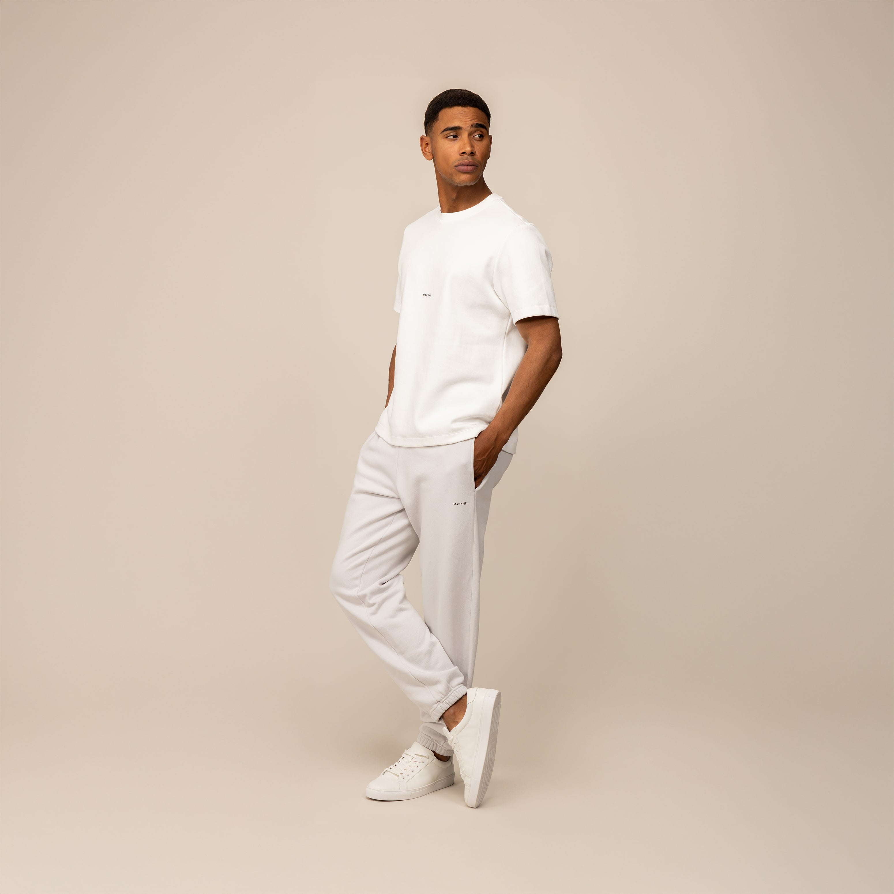 Model wearing white t-shirt and light grey joggers — premium luxury loungewear set by Marame for elevated comfort