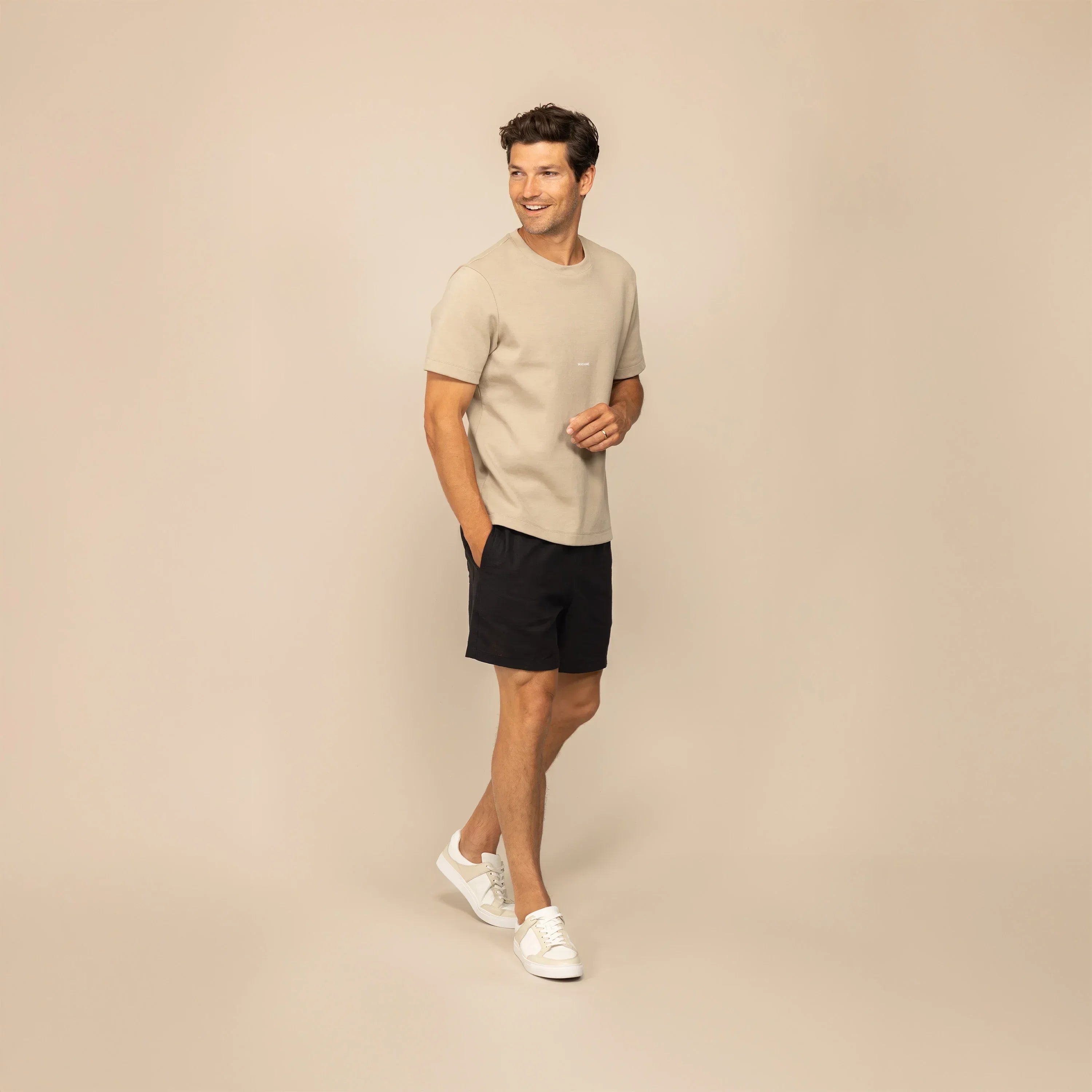 Man wearing black casual linen blend shorts, front view. |black