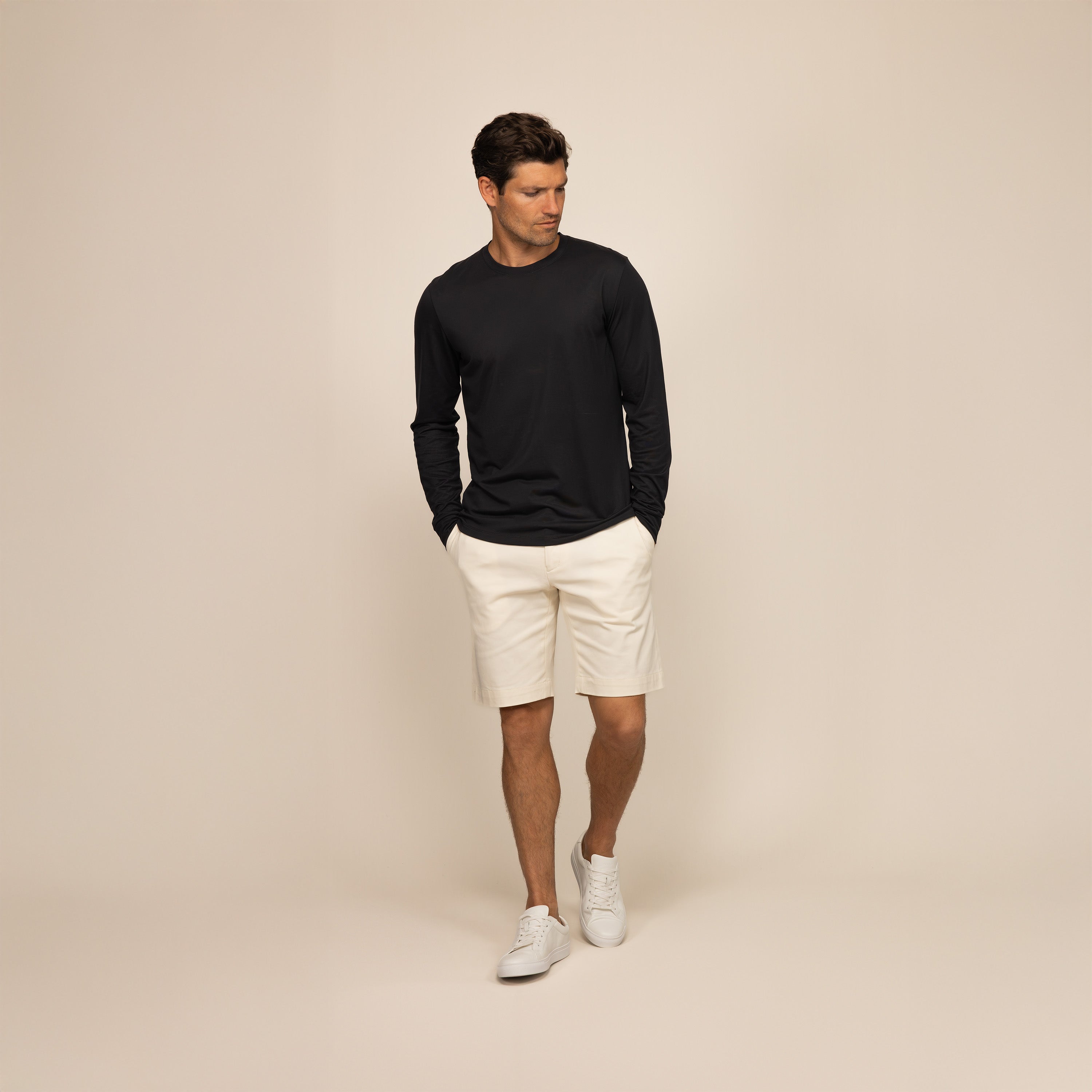 Man wearing a black long sleeve lyocell blend t-shirt, front view.