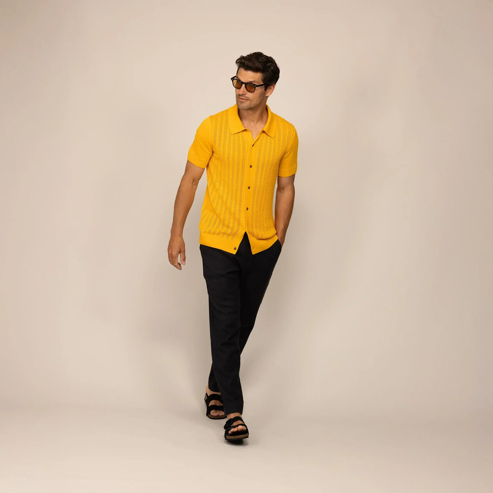 Man wearing Marame cable knit shirt in citrus, front view.