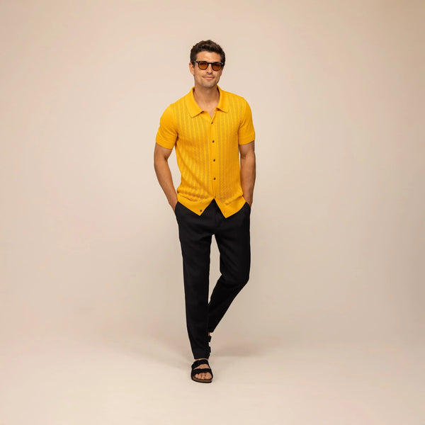 Man wearing cable knit shirt in citrus, front view.