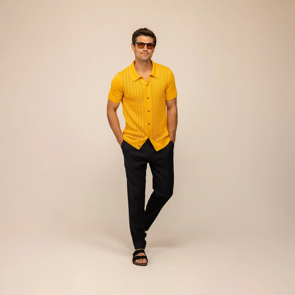 Man wearing cable knit shirt in citrus, front view.