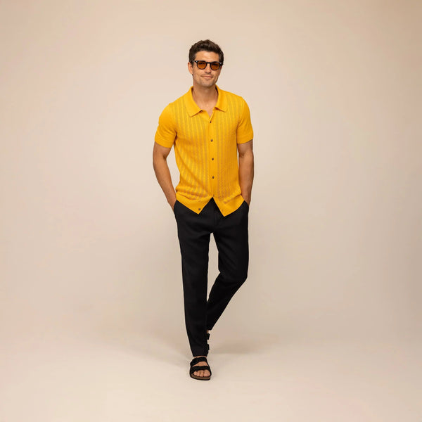 Man wearing cable knit shirt in citrus, front view. |citrus