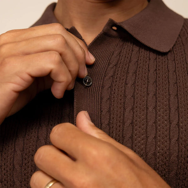Man wearing cable knit shirt in conker brown, closeup.
