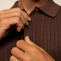 Man wearing cable knit shirt in conker brown, closeup.