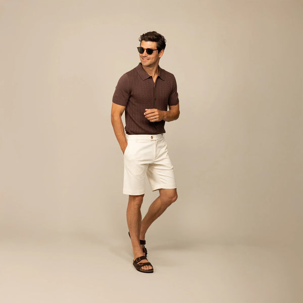 Man wearing Marame cable knit shirt in conker brown, front view.