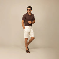 Man wearing Marame cable knit shirt in conker brown, front view.