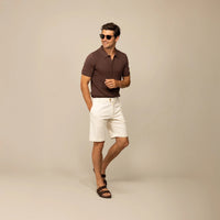 Man wearing Marame cable knit shirt in conker brown, front view. |conker brown