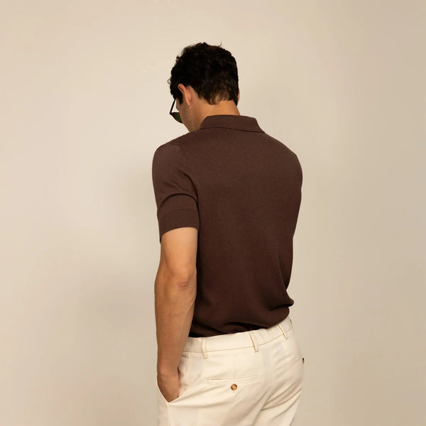 Man wearing cable knit shirt in conker brown, rear view.