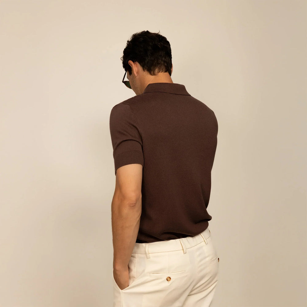 Man wearing cable knit shirt in conker brown, rear view.