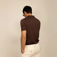 Man wearing cable knit shirt in conker brown, rear view.