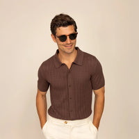 Man wearing Marame cable knit shirt in conker brown, front view.