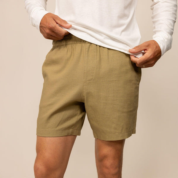 Man wearing Casual Linen Blend Shorts in Barley Green, front view.