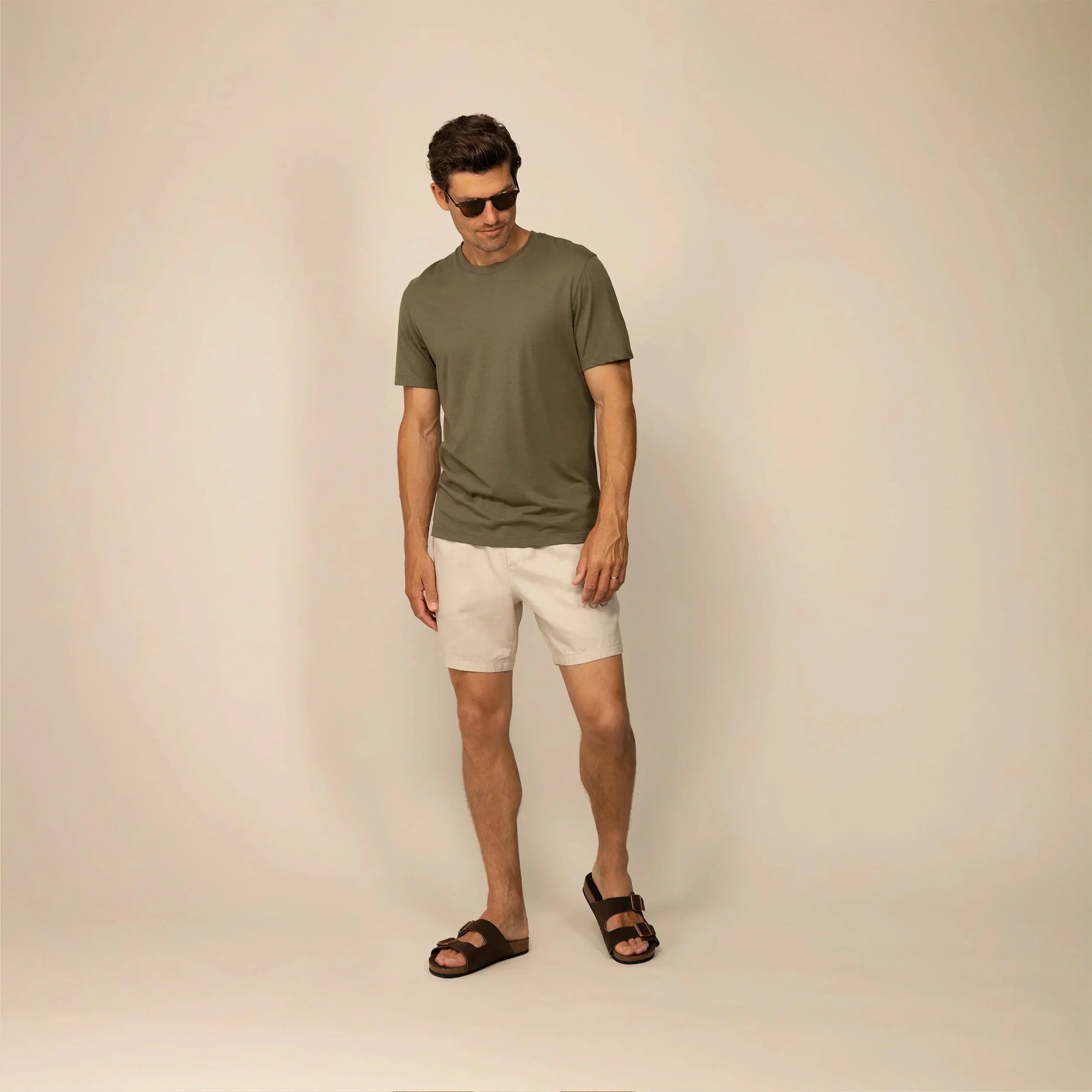 Man wearing casual linen blend shorts in natural sand, full shot. |natural sand