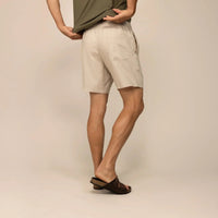 Man wearing casual linen blend shorts in natural sand, rear view. |natural sand
