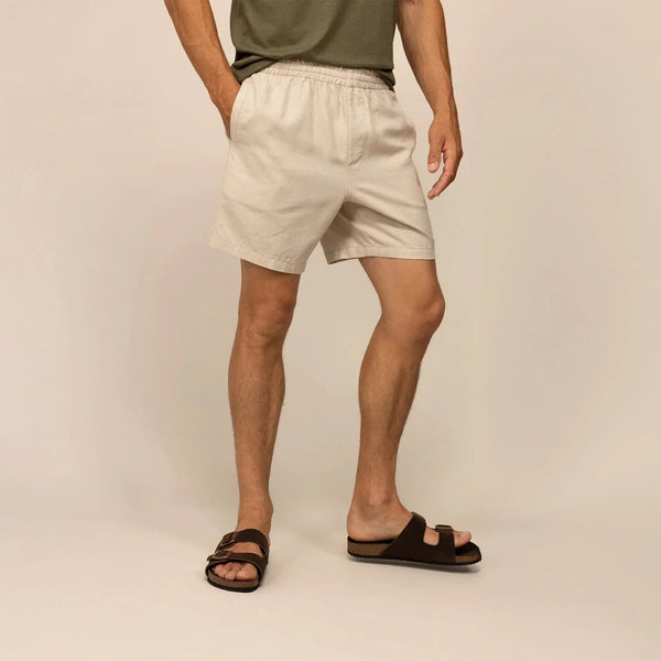 Man wearing casual linen blend shorts in natural sand, front view. |natural sand