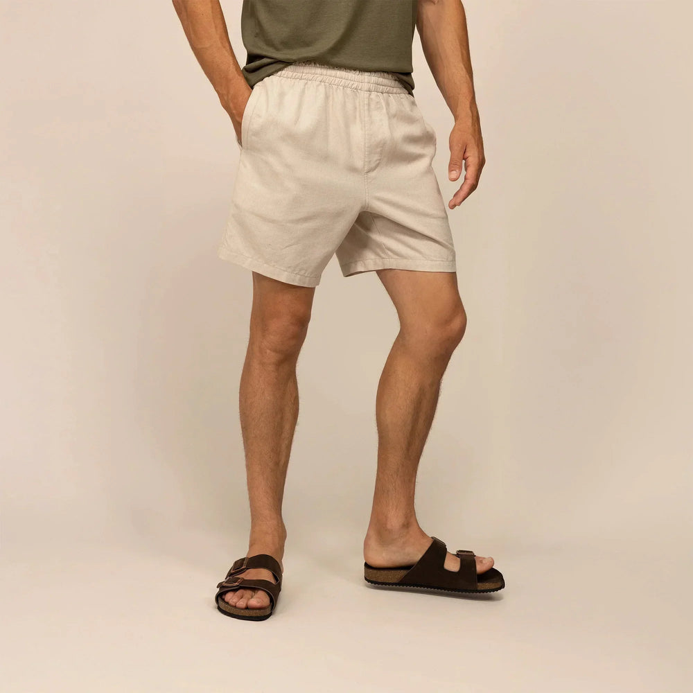 Man wearing casual linen blend shorts in natural sand, front view. |natural sand