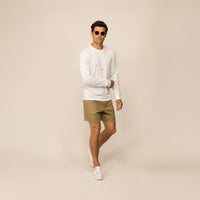 Man wearing Marame casual linen blend shorts in barley green, front view.