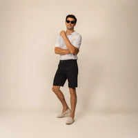 Man wearing Chino Shorts in Black, front view.